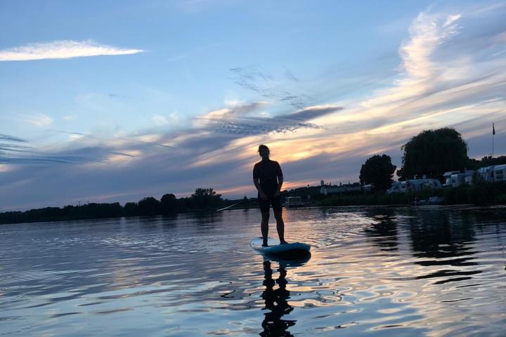a man standing next to a body of water