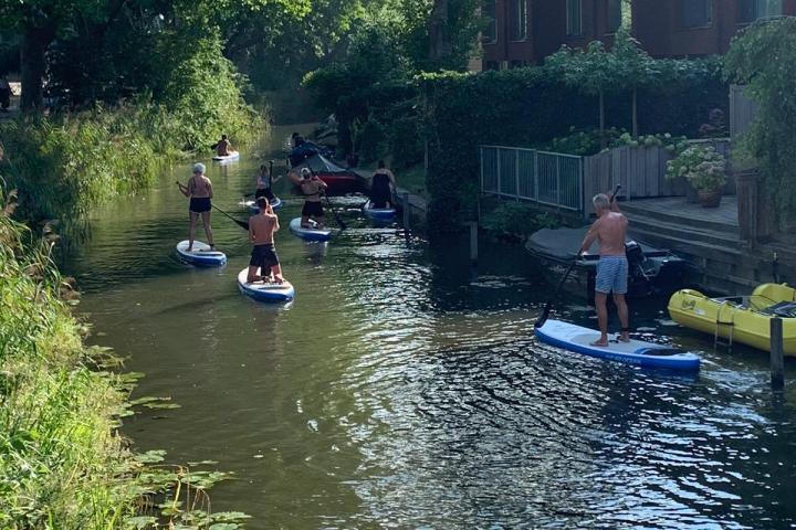a group of people riding on the back of a boat in the water