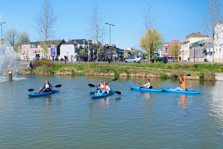 a group of people in a small boat in a body of water