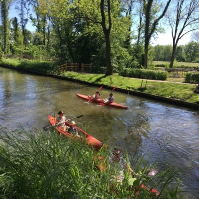 a group of people riding on the back of a boat on a river