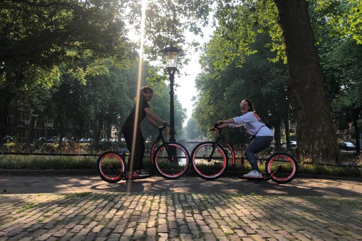 a group of people riding on the back of a bicycle
