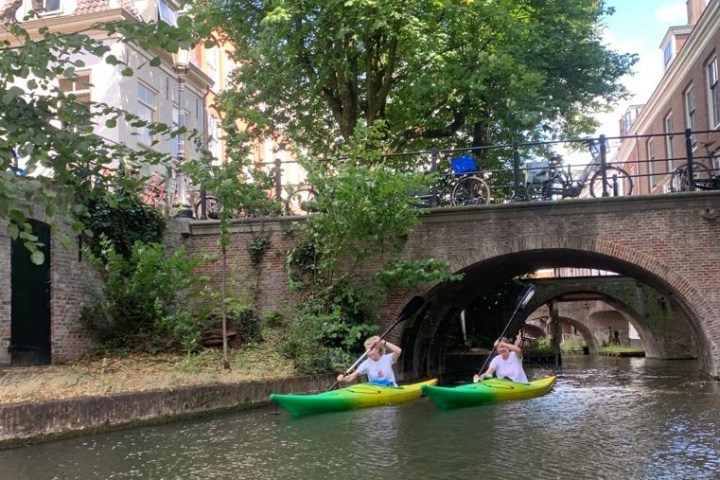 a person in a green boat on a river